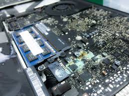 Liquid-damaged iPad being disassembled for internal inspection Corroded iPad motherboard after water exposure at TekRenewed Technician cleaning liquid residue from iPad circuit board Water-damaged iPad undergoing ultrasonic cleaning process